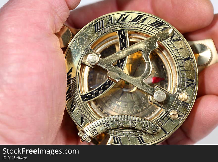 Hand with antique, bronze compass. Hand with antique, bronze compass.