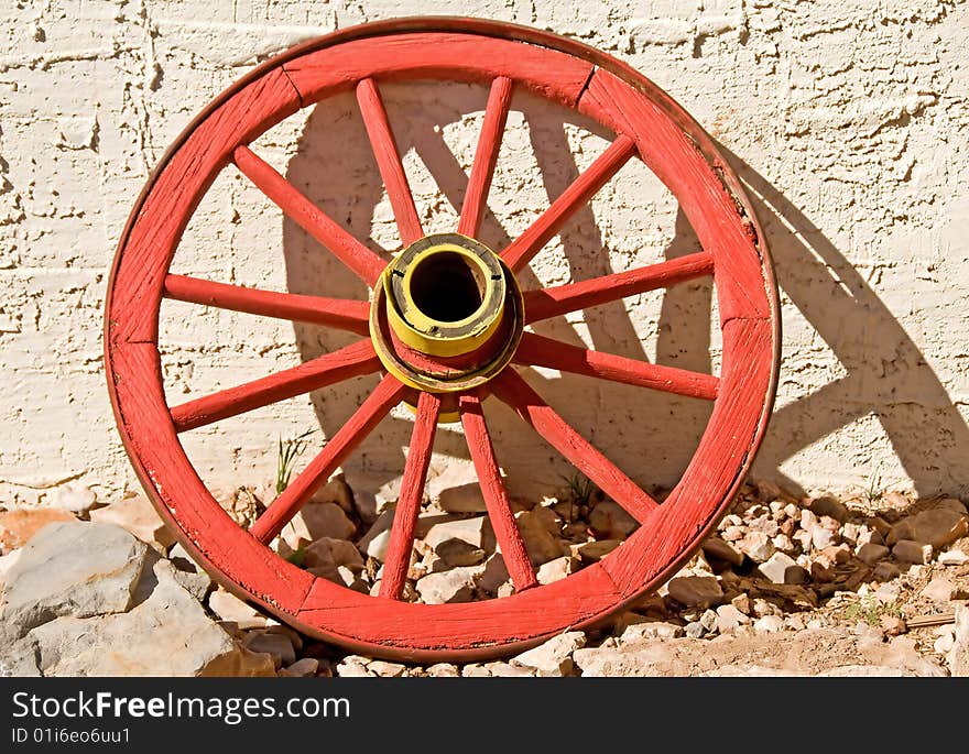 A brightly colored vintage wagon wheel. A brightly colored vintage wagon wheel