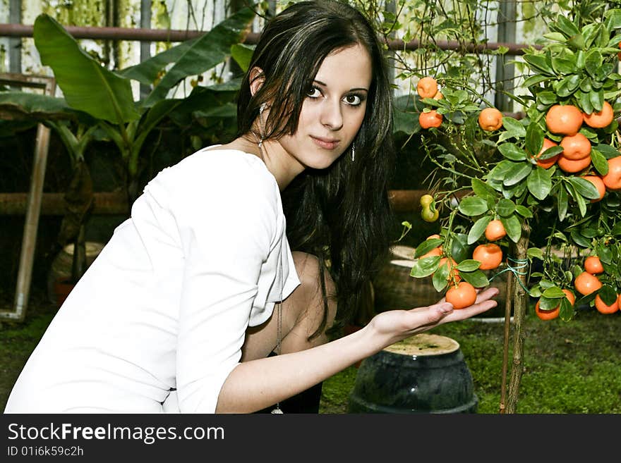 Portrait of a young girl holding the mandarin. Portrait of a young girl holding the mandarin