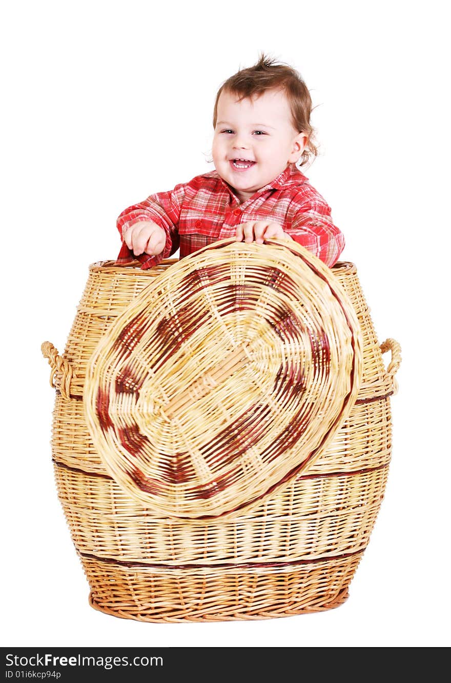 Baby boy sitting in basket. Isolated