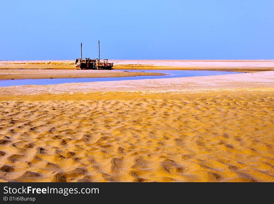 Fishing boat and sand beach