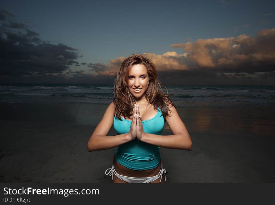 Woman on the beach with a beautiful skyscape in the background