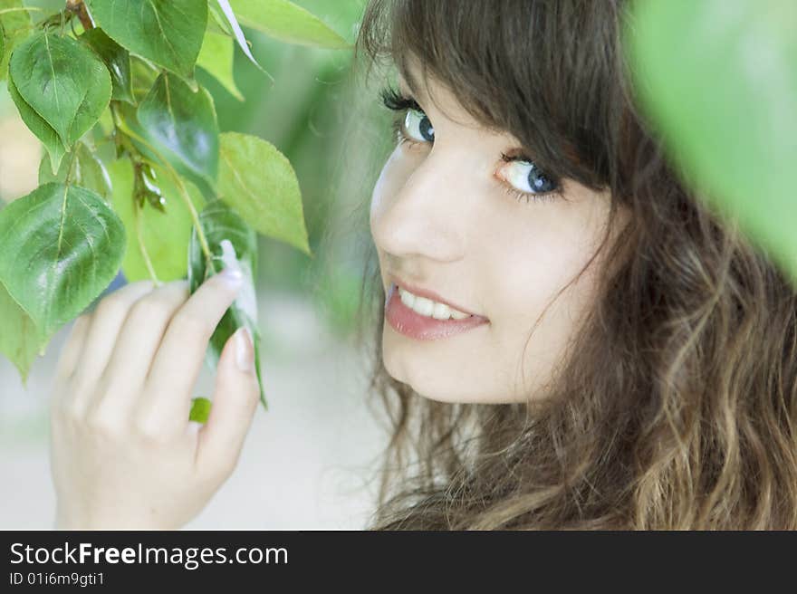 Girl With Blue Eyes In The Foliage