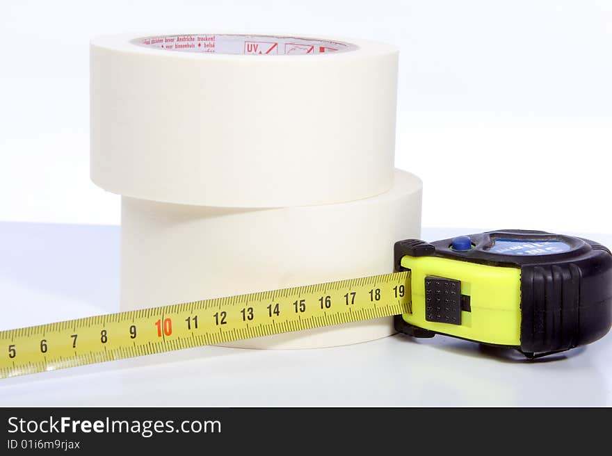 Photograph of rolls of tape and a Tape measure. Photograph of rolls of tape and a Tape measure