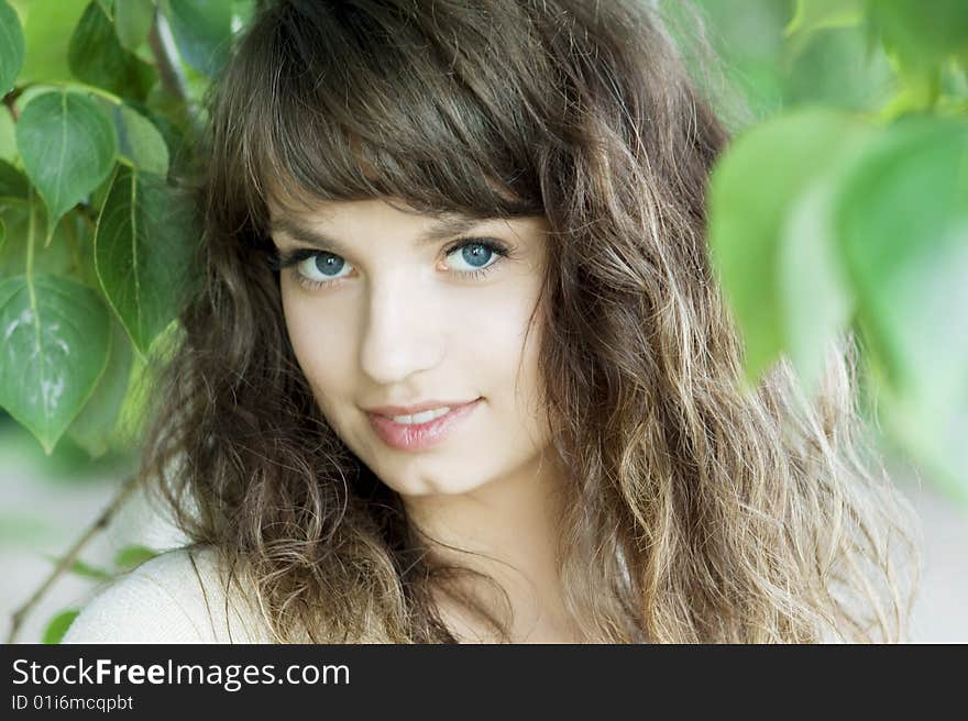 Girl With Blue Eyes In The Foliage