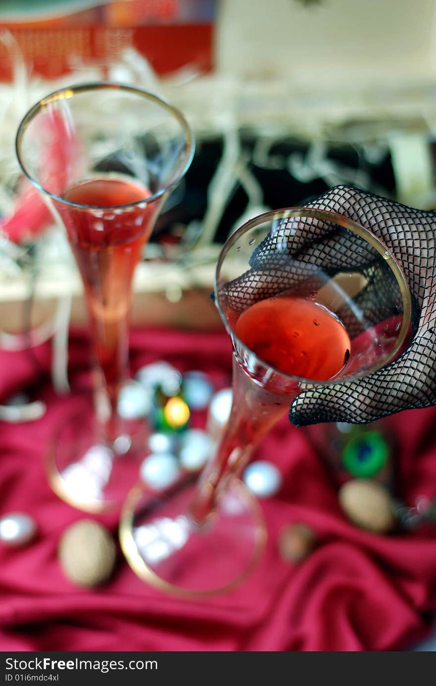 Women's hand picking up glass of wine. Women's hand picking up glass of wine