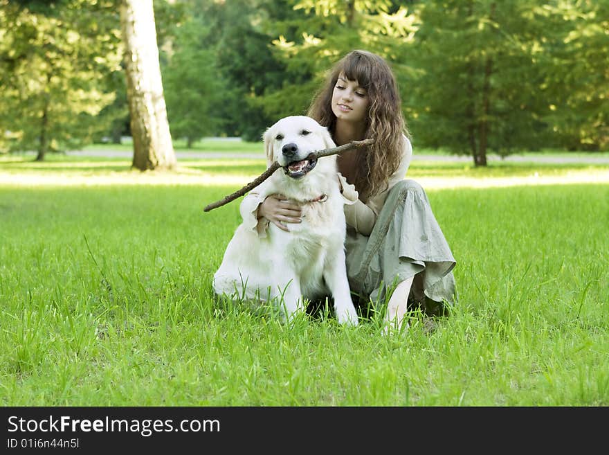 Girl With The Golden Retriever In The Park