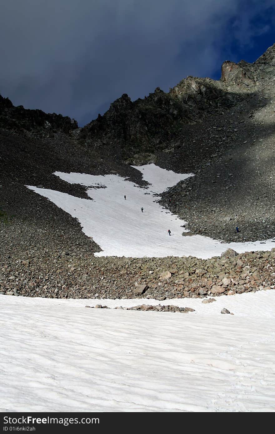 Alpinists descending from a mountain pass at Caucasus. July 2007. Alpinists descending from a mountain pass at Caucasus. July 2007.