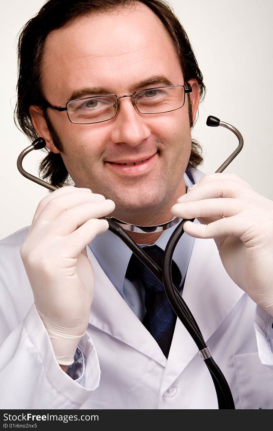 Smiling doctor with stethoscope over white. Smiling doctor with stethoscope over white