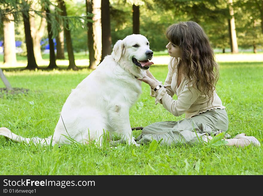 Girl with the golden retriever in the park