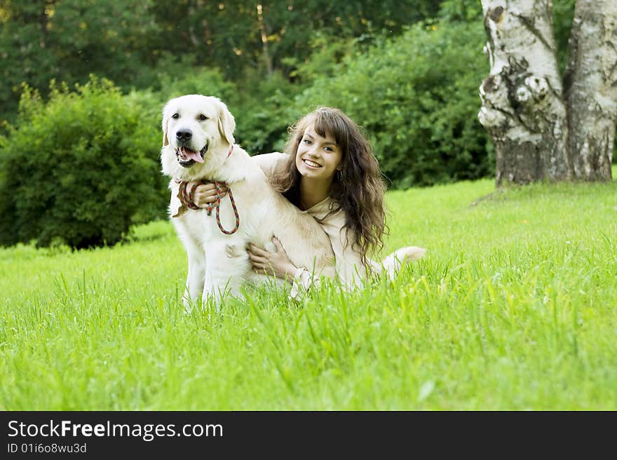 Girl with the golden retriever in the park