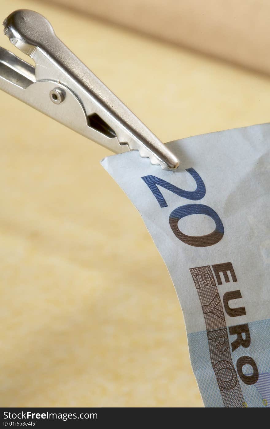 Blue twenty euro banknote with tweezers