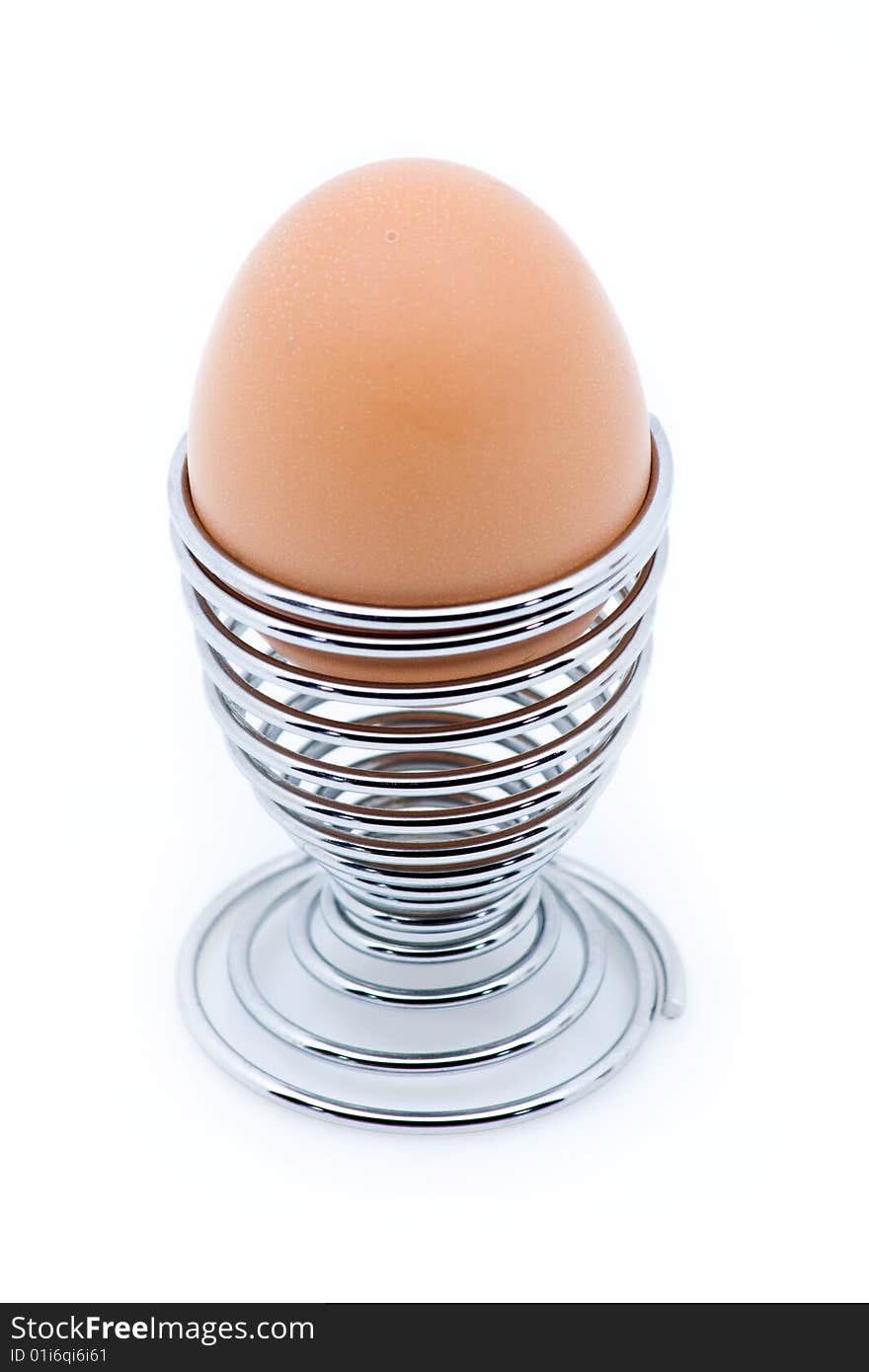 An egg on an eggcup isolated on white