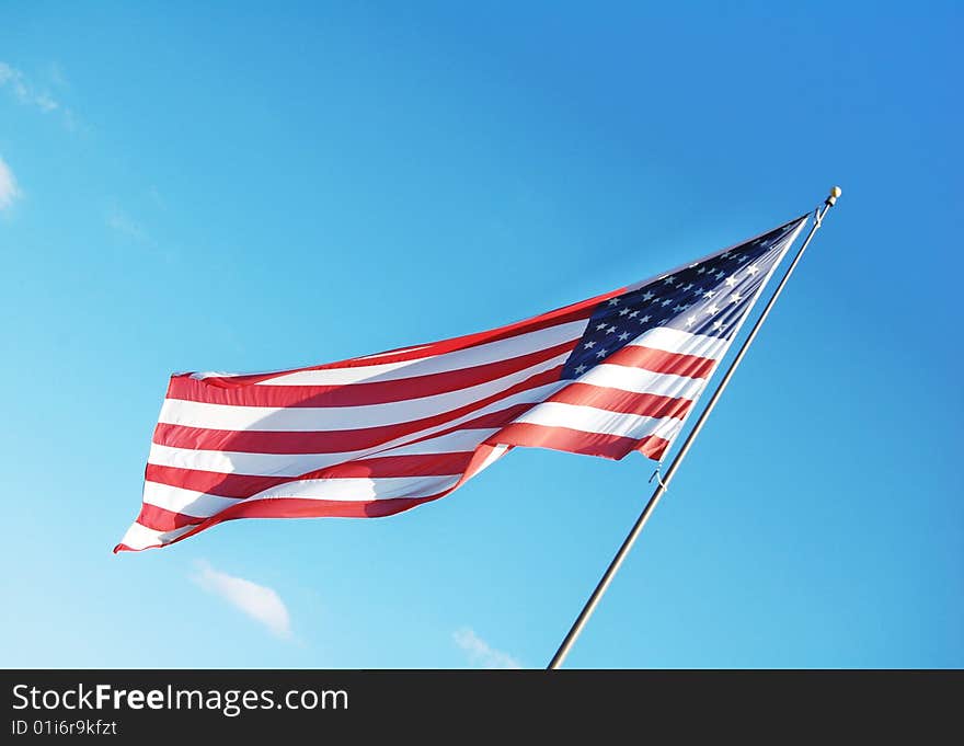 American flag with blue sky as the background