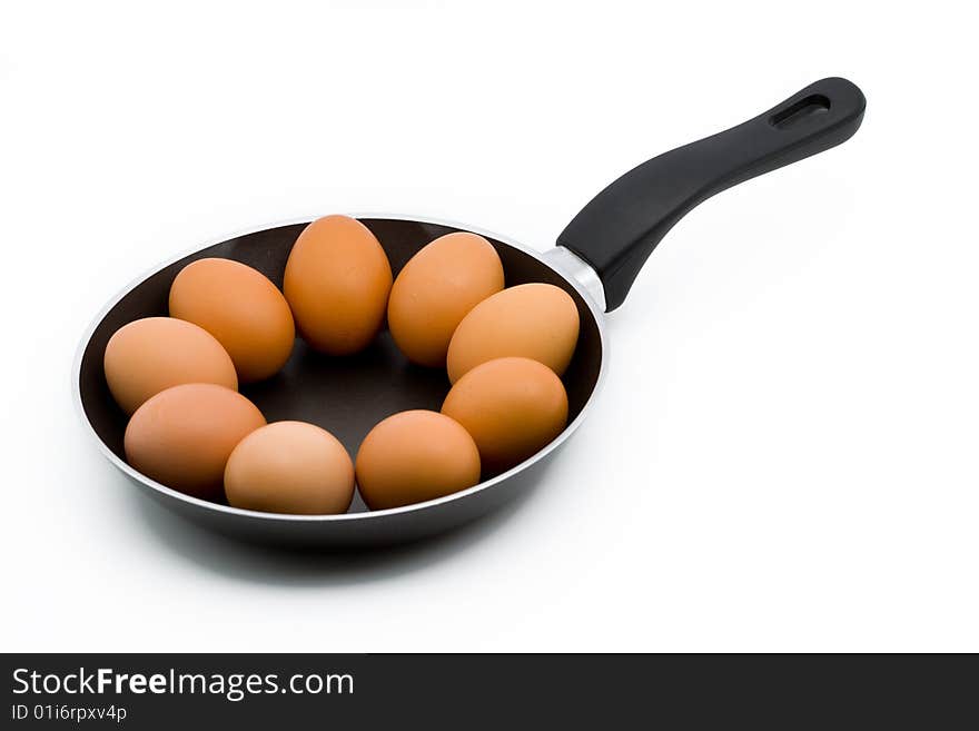 Whole raw eggs in a pan isolated on white