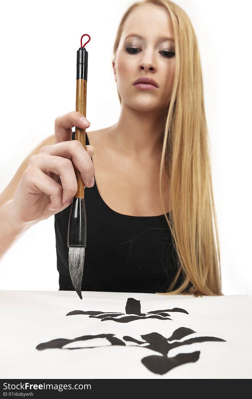 Blond woman writing Chinese Calligraphy: Peace