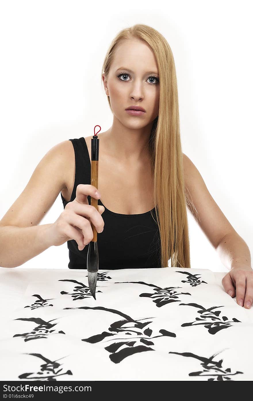 Woman writing Chinese Calligraphy: LOVE