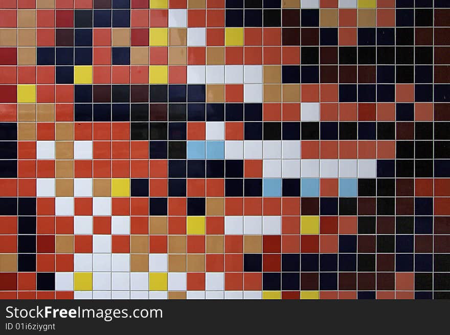 Colorful mosaic tiled wall of new danish building. Reds, yellow, blue, brown, white and more.