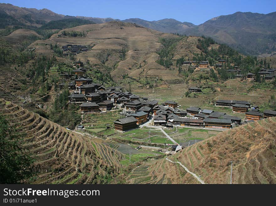 A Chinese minority village in the middle of steep rice terrances in Guangxi Province of southern China. A Chinese minority village in the middle of steep rice terrances in Guangxi Province of southern China.