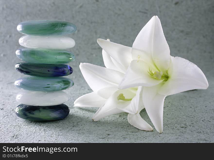 Stack of zen stones and lilum flower. Stack of zen stones and lilum flower.