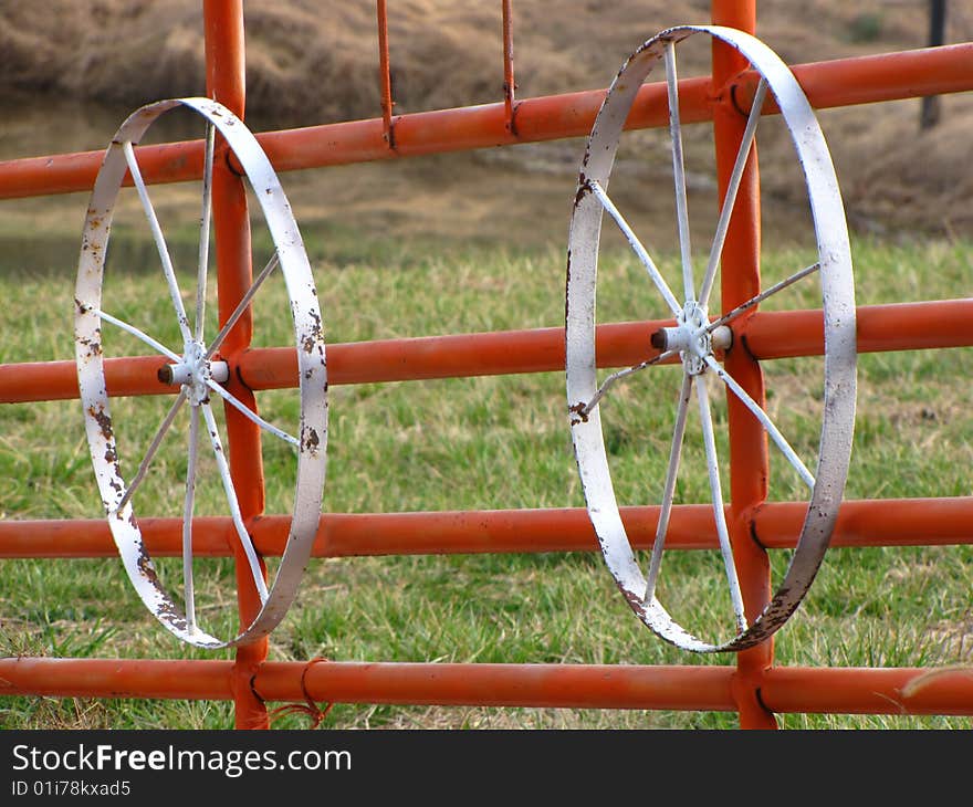 Two white wheels on a red gate. Two white wheels on a red gate