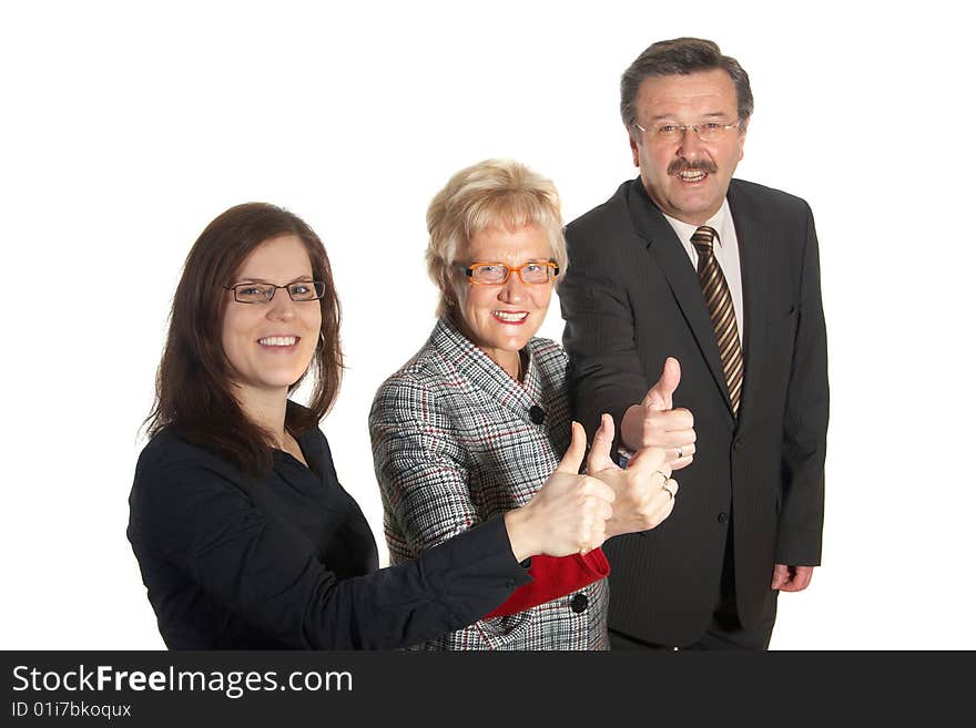 Small group of business people in business suits standing looking forward. Focus is on the young woman in front. Small group of business people in business suits standing looking forward. Focus is on the young woman in front.