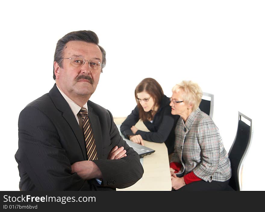 Businessman in office environment. Three people with focus on mature boss in front. Isolated over white. Businessman in office environment. Three people with focus on mature boss in front. Isolated over white.