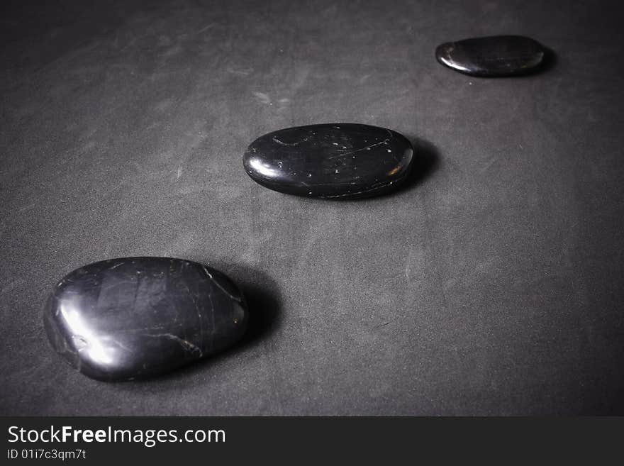 Zen stones on a gray background.