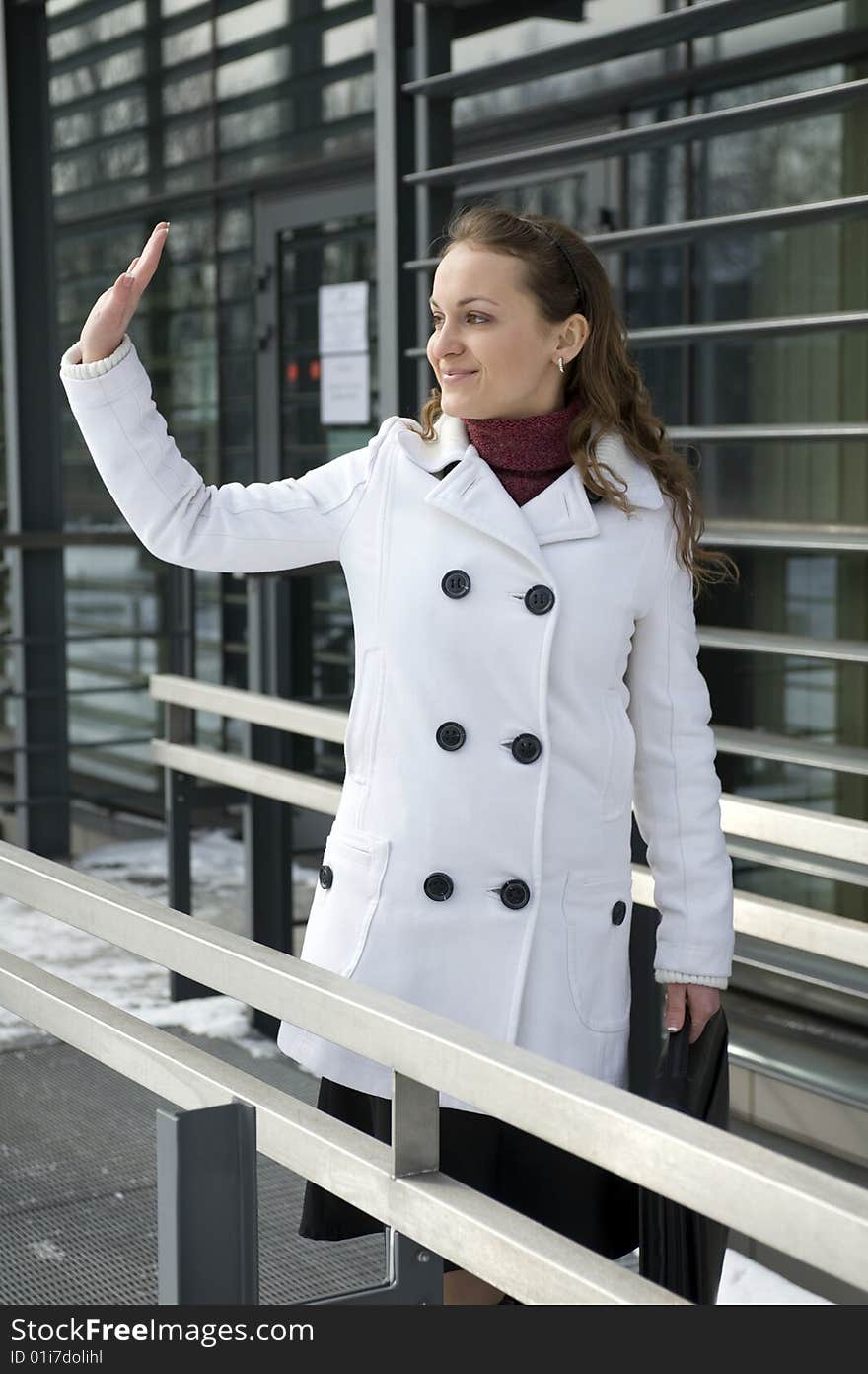 Woman with the lifted hand on the greeting