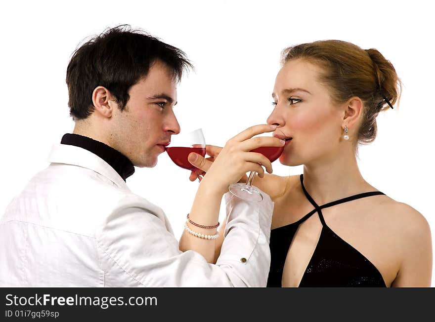 The man and the woman in white clothes with red wine. The man and the woman in white clothes with red wine