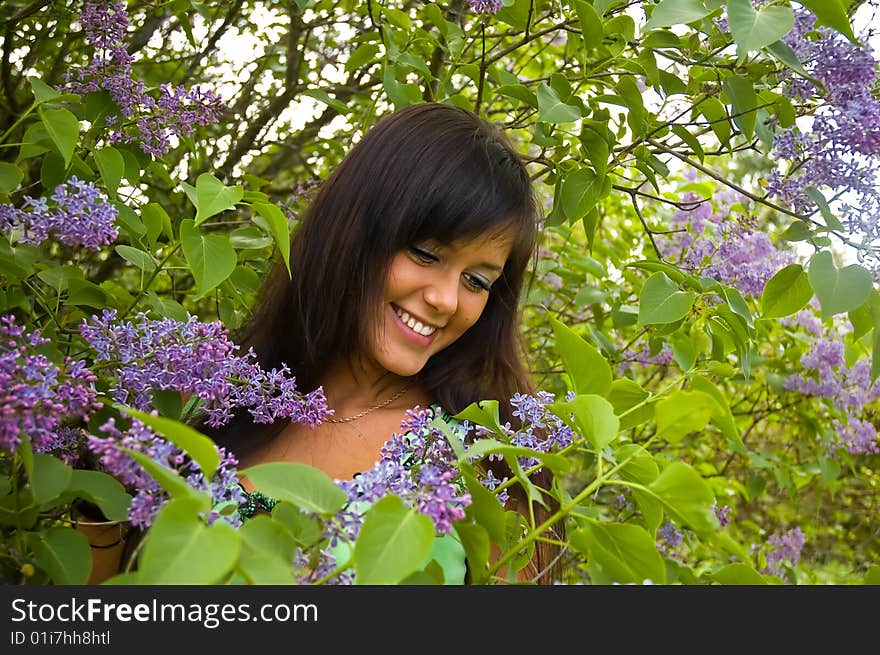 The  girl and blossoming lilac