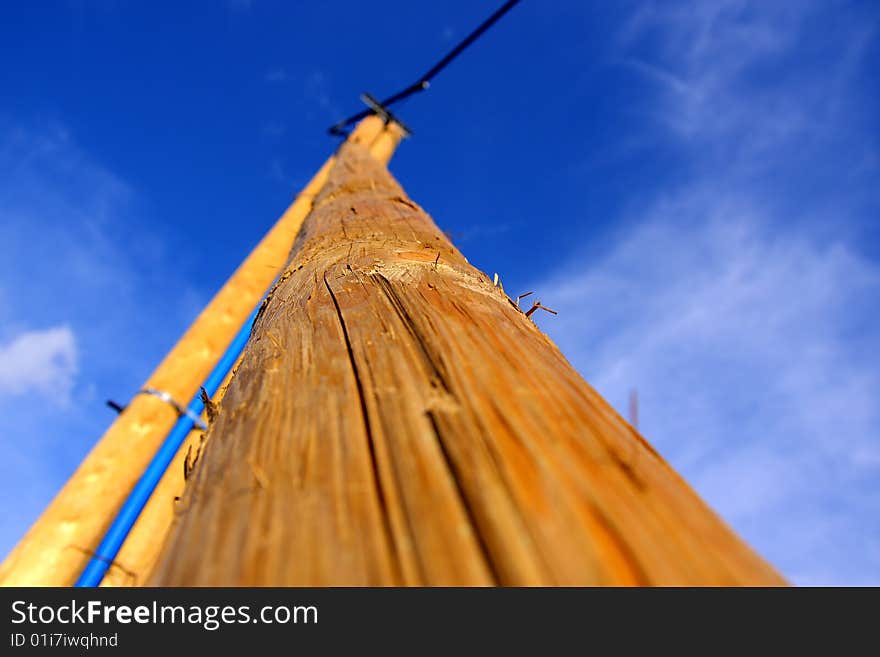 The background of blue skies and a high wooden pole