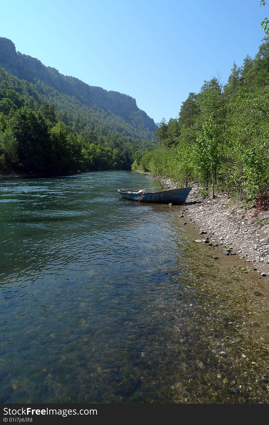 River view with lonely boat and distant mountain. River view with lonely boat and distant mountain