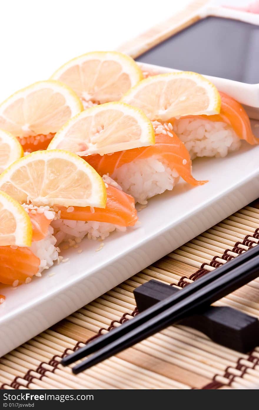 Plate with sushi and black chopsticks