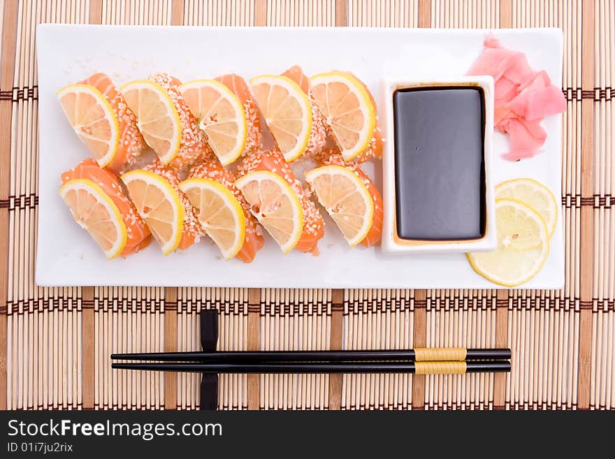 Plate with sushi and black chopsticks