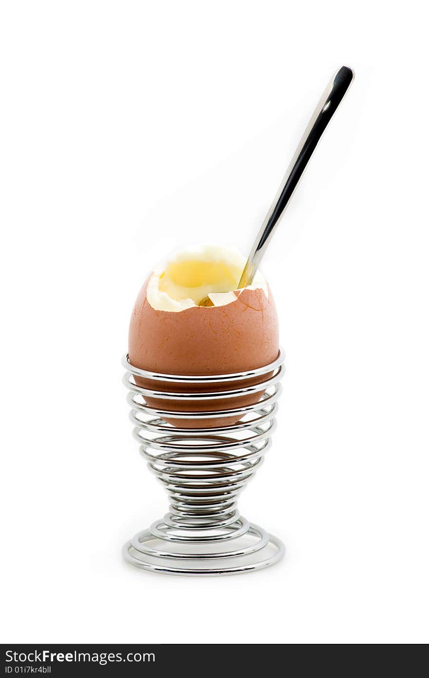 An eggcup with an pealed egg