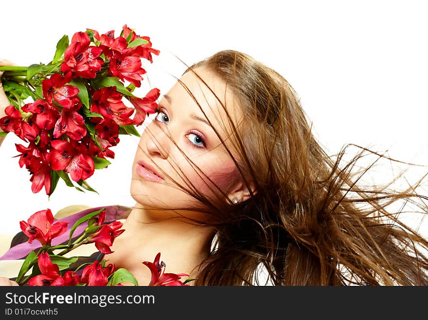 Attractive young woman with flowers, wind in hair. Attractive young woman with flowers, wind in hair