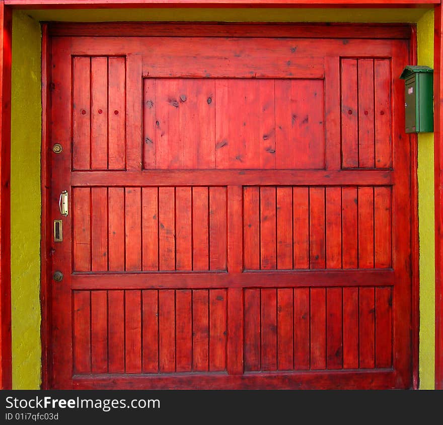 Colourful wooden door painted in bright red. Colourful wooden door painted in bright red