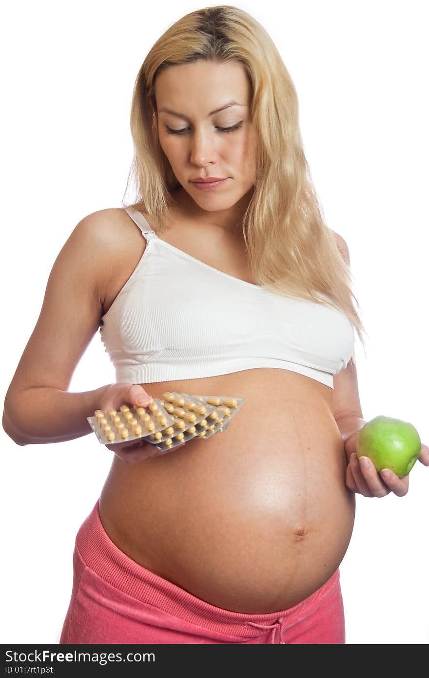 Pregnant woman with apple and tablets isolated on a white. Pregnant woman with apple and tablets isolated on a white