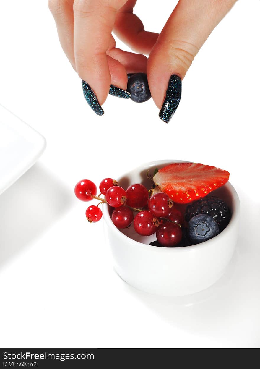 Fresh Berries Bowl and Beauty Woman Hand. Isolated on White Background