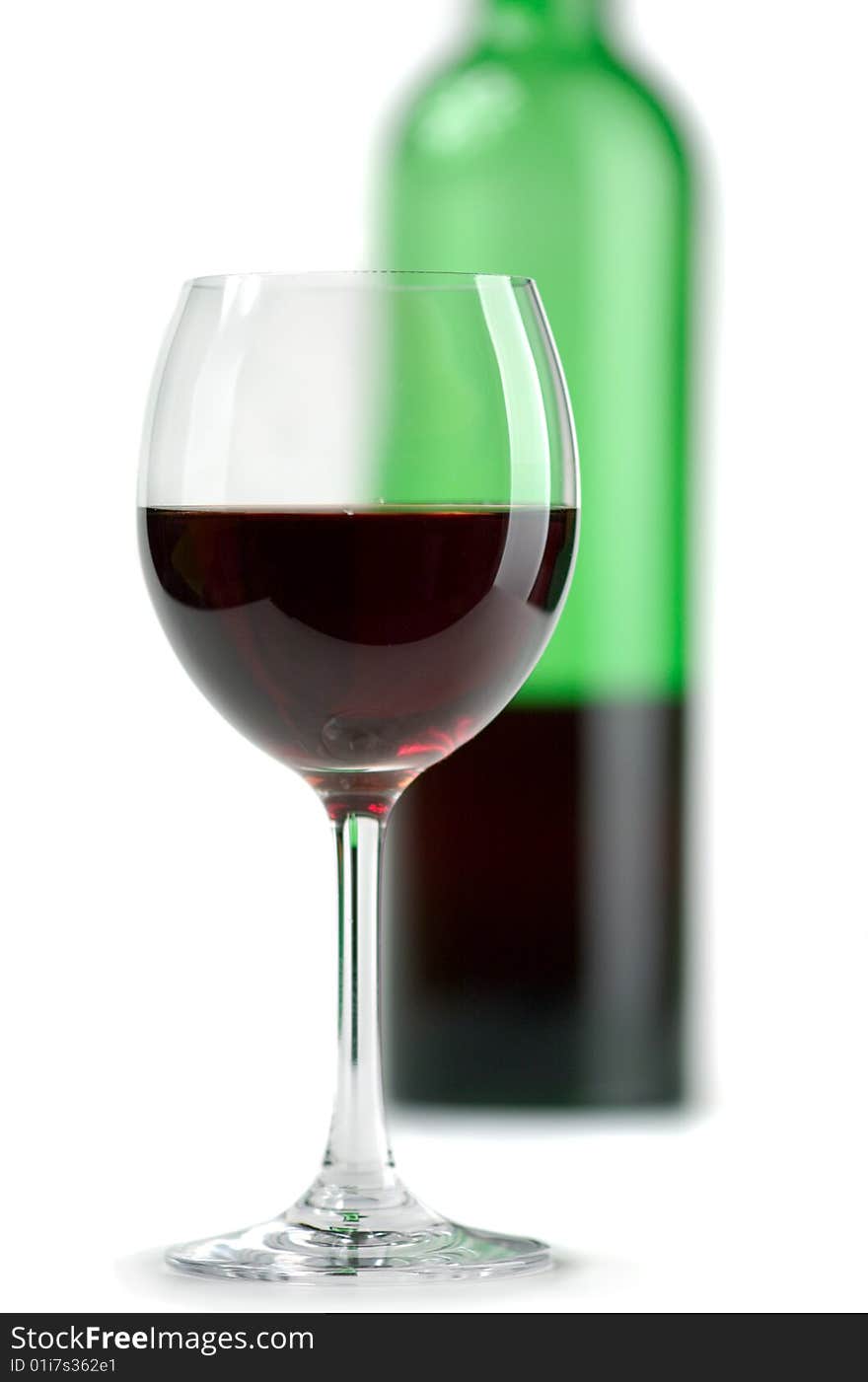 Bottle and glass of red wine on a white background