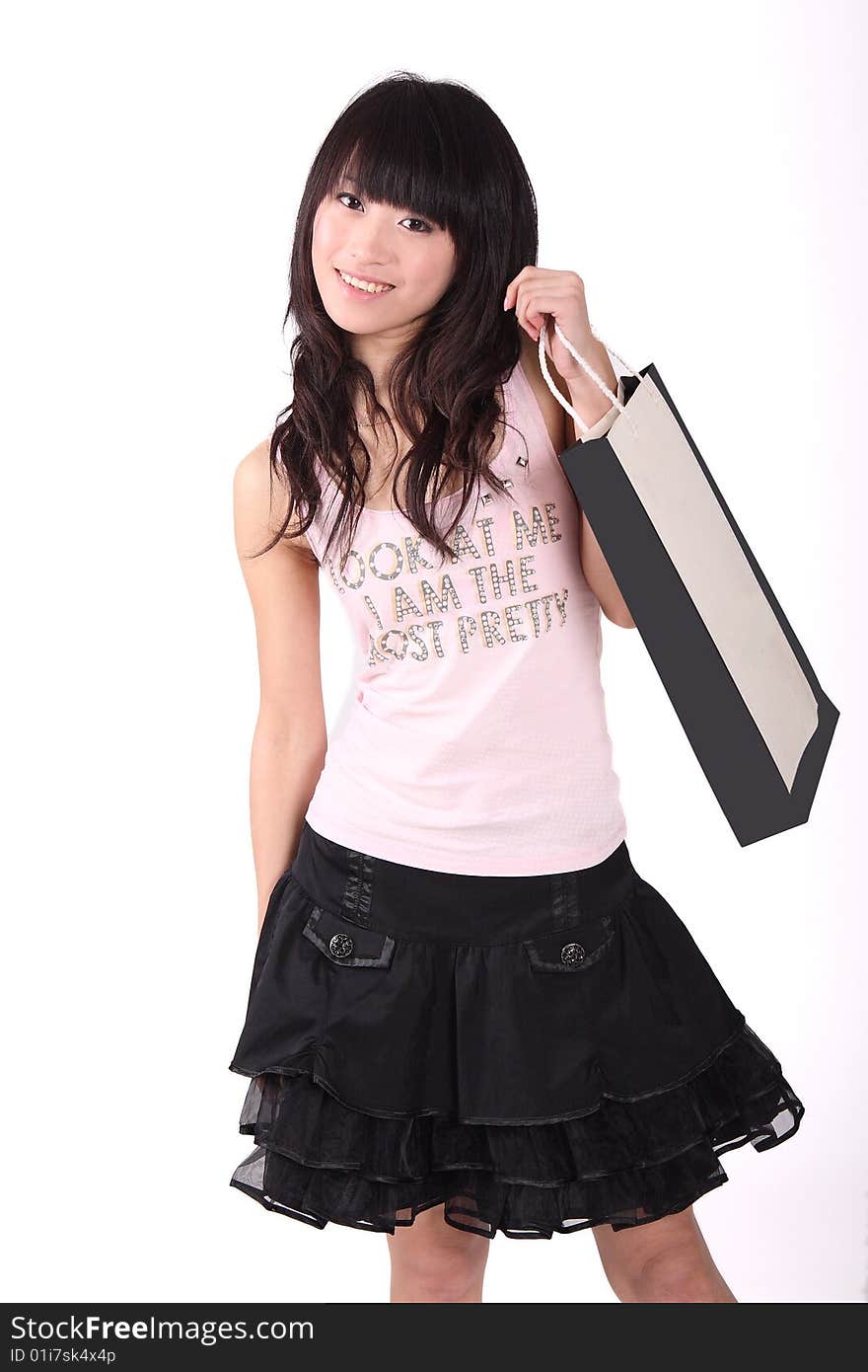 A beautiful Asian girl  holds a shopping bag  on white background. A beautiful Asian girl  holds a shopping bag  on white background.