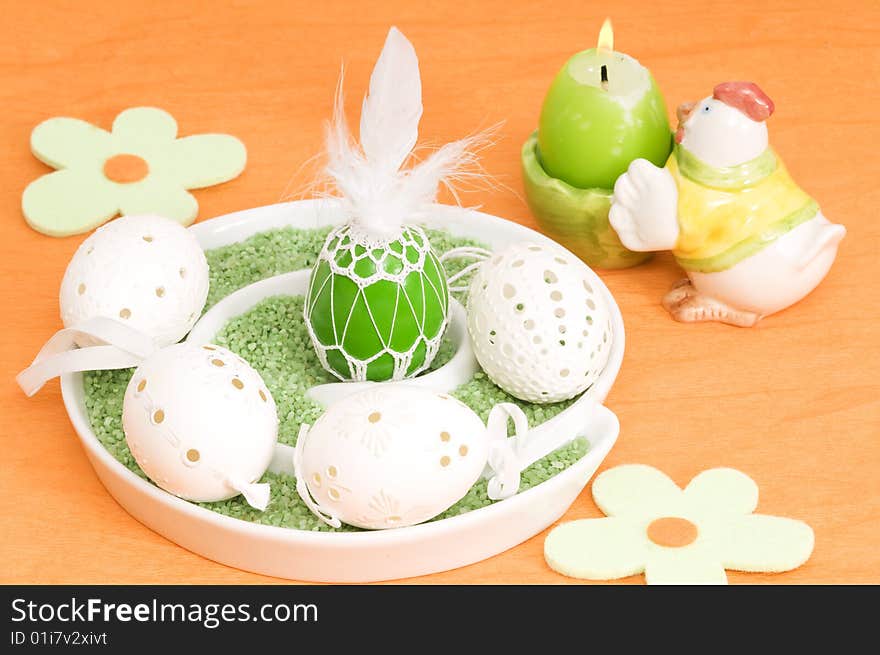 Easter decoration with eggs and candle on orange background. Easter decoration with eggs and candle on orange background