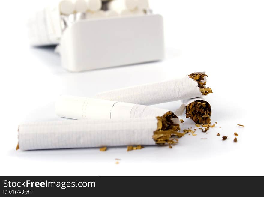 Broken cigarettes on white background