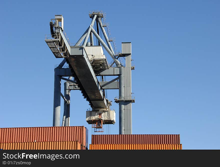 Large crane moving containers at the port