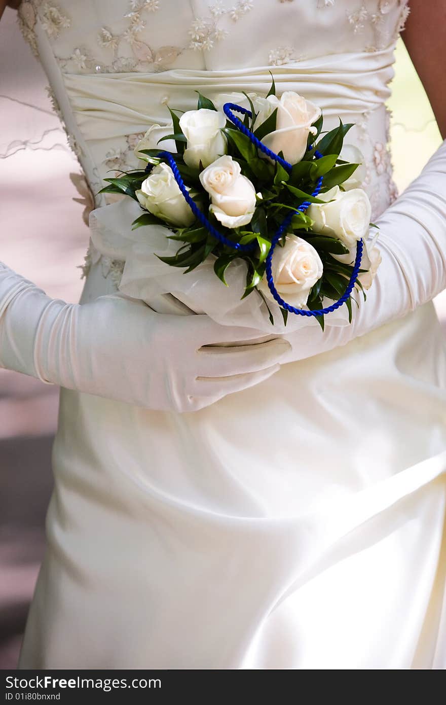 Bride in silk gloves hold beautiful bunch of flowers in her hands. Bride in silk gloves hold beautiful bunch of flowers in her hands