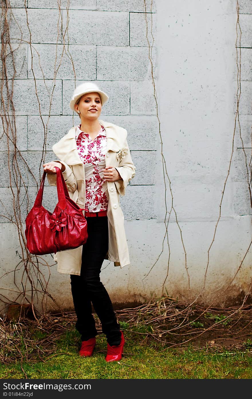 Beautiful young woman shows her red bag. Beautiful young woman shows her red bag