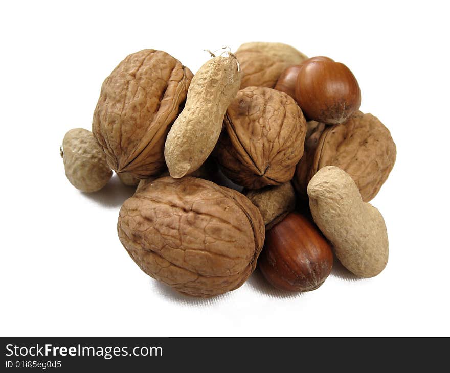 An assortment of nuts with their shells on. An assortment of nuts with their shells on