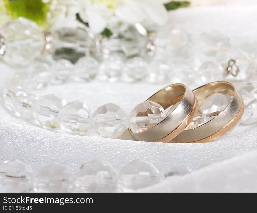 Closeup of wedding rings and beads