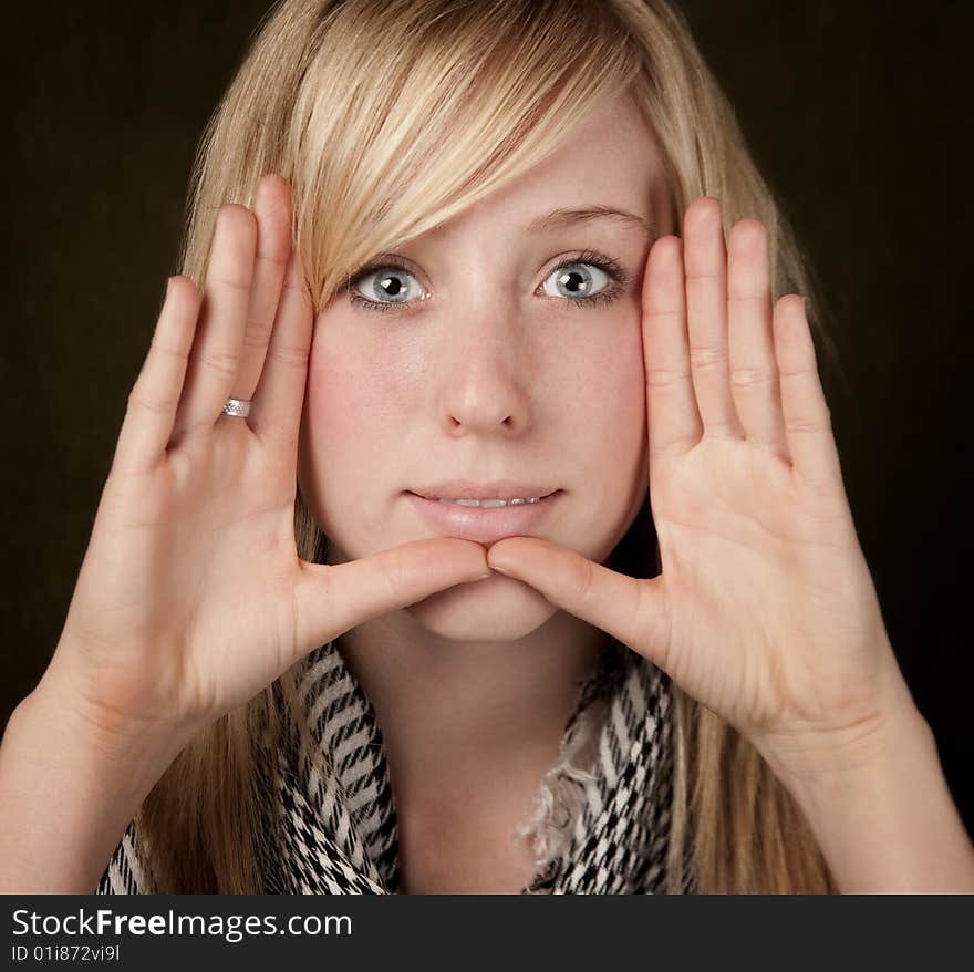 Pretty teenager framing her face